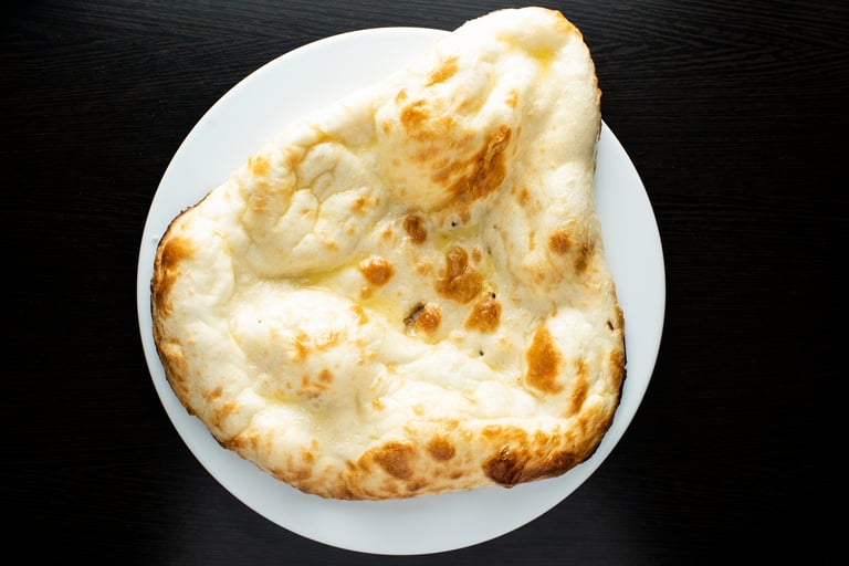 Tandoori Butter Naan, nan, nun, bread or roti served in dish isolated dark background top view of indian spices, bangladeshi and pakistani food