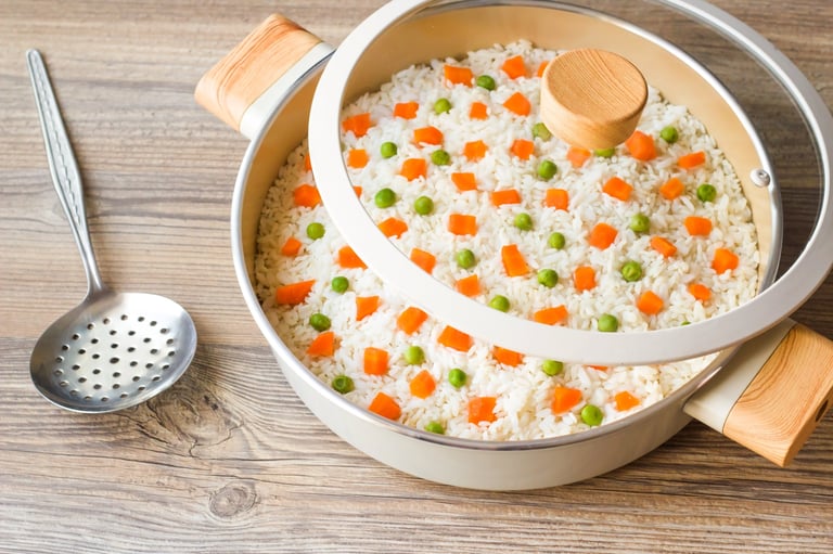 Traditional Turkish vegetable rice in ceramic rice pot,on wooden surface with metal rice spatula