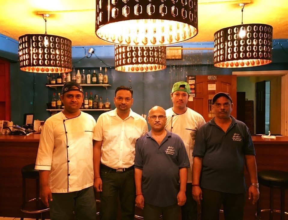 Shiv Shakti restaurant staff team together under decorative chandeliers